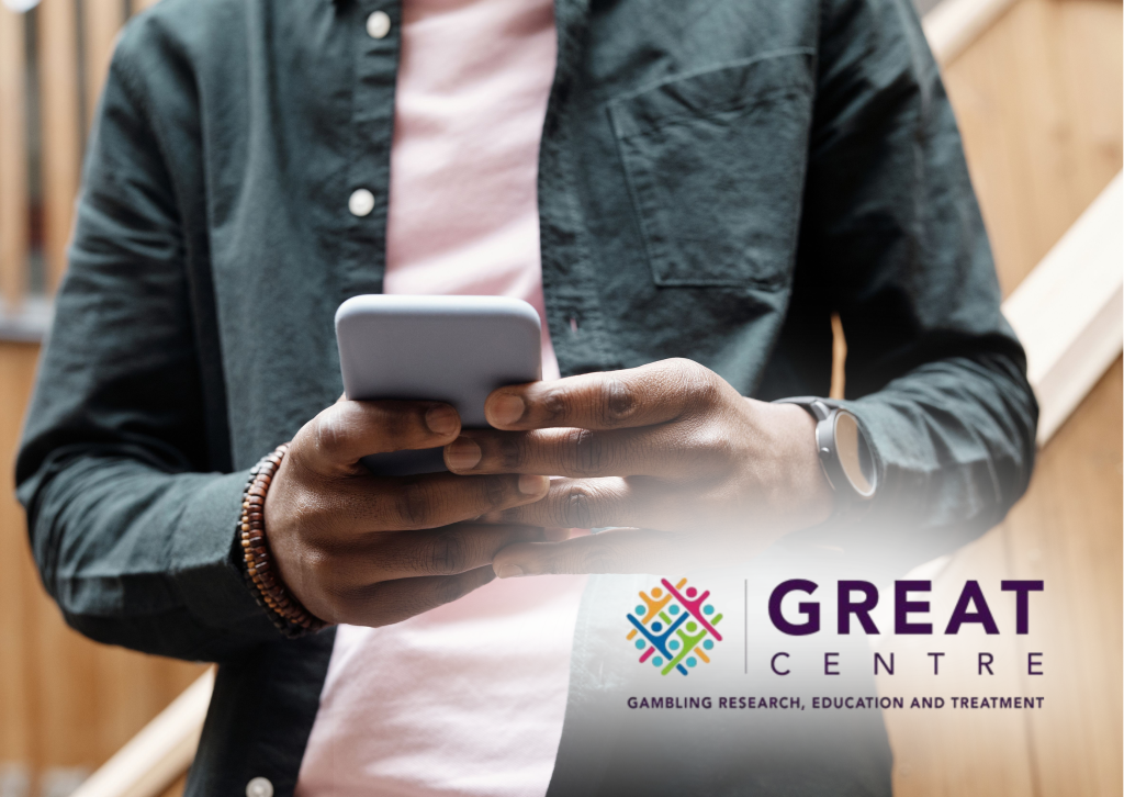 An image a person on their phone with the Gambling Research, Education and Treatment Centre logo in the bottom right corner.