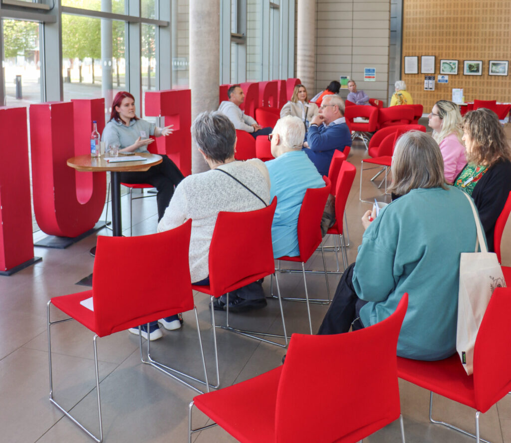 Attendees sitting at one of the 'Soapbox Scientists' chats in the Haydn Ellis Building reception area