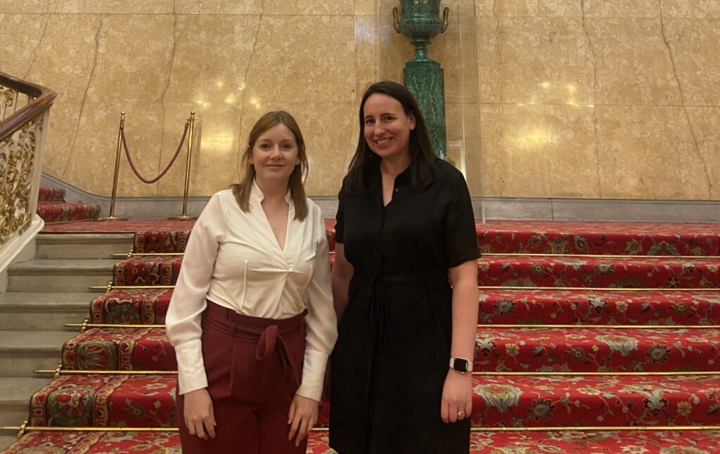 Dr Amy Lynham (left) and Dr Catrin Lewis (right) standing on the steps of Lancaster House, London.