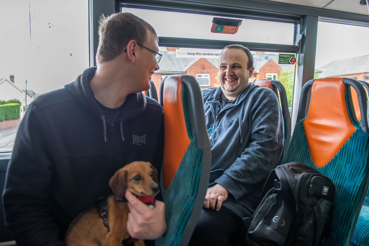 Two friends laughing on a busy